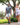 man and women walking down path with trees in background