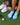 women with blue Balega socks on green grass. Golf equipment around socks. 